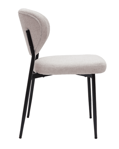 An armless dining chair featuring a curved, upholstered backrest and a complementary upholstered seat. The chair stands on four slender, tapered black metal legs, giving it a minimalist and modern aesthetic. The upholstery is a light beige or off-white fabric. — 3D model