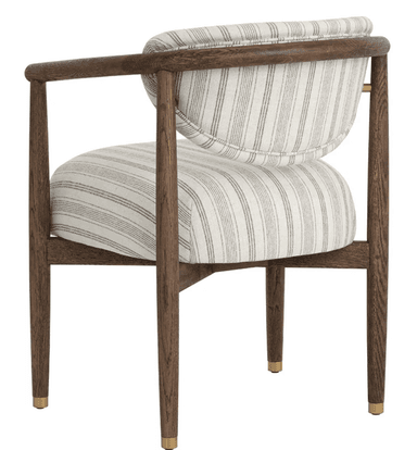 An armchair with a wooden frame and upholstered seat and back. The frame has a dark wood finish with a visible grain. The seat and back are upholstered in a fabric with a vertical stripe pattern in white and grey. The arms are curved and extend from the backrest to the front legs. The legs are tapered and capped with brass accents. — 3D model