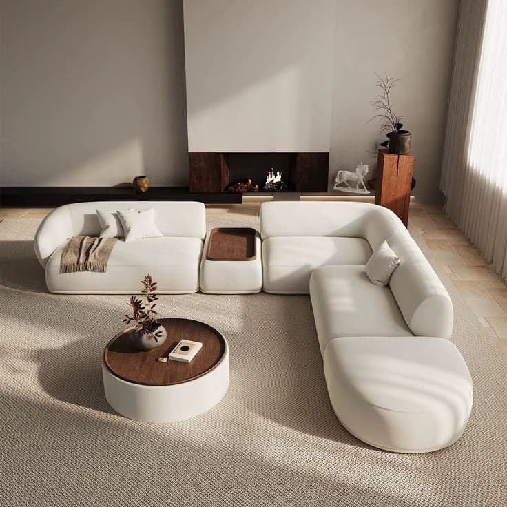 A modern modular sectional sofa in light fabric, featuring rounded contours, an integrated wooden tray, and a coordinating round coffee table with a wooden top. — 3D model