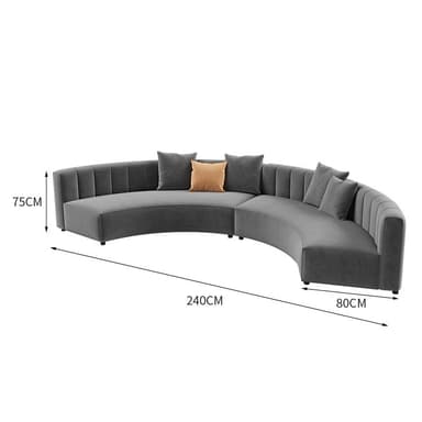 A contemporary curved sectional sofa upholstered in grey velvet, featuring channel tufting on the backrests. The sofa is composed of two modular pieces that form a crescent shape, providing ample seating. It rests on discreet, low-profile feet and comes with several matching grey throw pillows and one contrasting light brown throw pillow. — 3D model