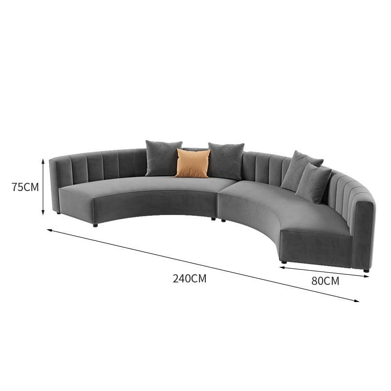 A contemporary curved sectional sofa upholstered in grey velvet, featuring channel tufting on the backrests. The sofa is composed of two modular pieces that form a crescent shape, providing ample seating. It rests on discreet, low-profile feet and comes with several matching grey throw pillows and one contrasting light brown throw pillow. — 3D model