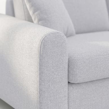 A close-up of the armrest and part of the backrest of a contemporary upholstered sofa, featuring light grey textured fabric. — 3D model