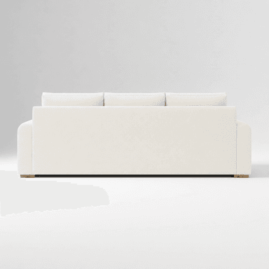 A contemporary three-seater sofa, viewed from the rear, featuring three loose back cushions and a low-profile base. The sofa is upholstered in a light-colored, possibly off-white or cream, textured fabric. The arms appear gently rounded on the outer edges. Small, recessed wooden feet are visible at the base corners. — 3D model