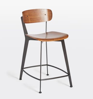 A bar stool with a backrest, featuring a wooden seat and back panel, supported by a dark metal frame. The seat and back panel appear to be made of bent wood or plywood with a wood grain finish. The frame consists of angled legs connected by a footrest at the bottom and supports for the seat and back. The design is modern and minimalist. — 3D model