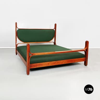 A daybed with a wooden frame and a green upholstered mattress. The frame has a rectangular base with two vertical supports at the head and a single vertical support at the foot. The headboard is curved and upholstered in green fabric. The armrests are integrated into the frame and extend from the headboard supports. — 3D model