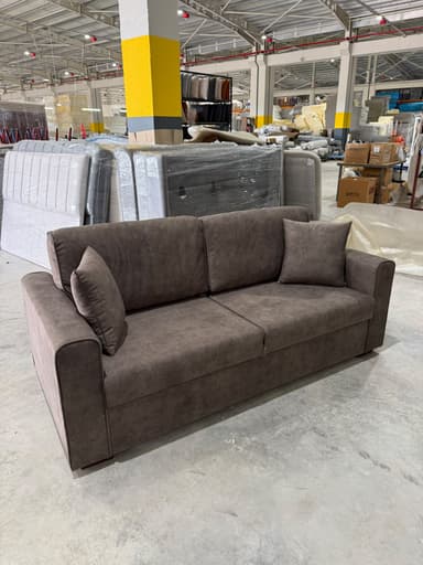 A modern two-seater sofa featuring a clean, minimalist design with tailored fabric upholstery. It has two individual seat cushions, two large back cushions, and straight track arms. A small square throw pillow is included, matching the sofa's upholstery. — 3D model