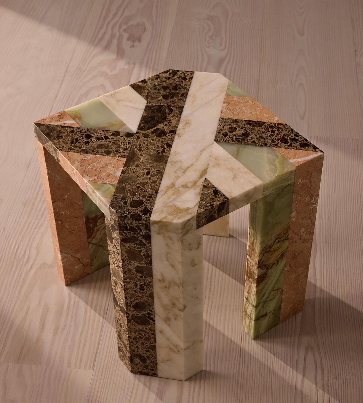 A polygonal side table constructed from various types of marble, arranged in a geometric, segmented pattern. The table has four legs and a faceted top. The marbling and color variations across the different marble segments create a striking visual effect. — 3D model