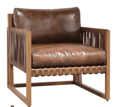 A contemporary lounge armchair featuring a robust, exposed light-toned wooden frame and plush, distressed brown leather upholstery. The design incorporates distinctive woven leather straps on the armrests and front lower rail, secured with metal studs. It has deep seat and back cushions, presenting a blend of rustic and modern aesthetics. — 3D model