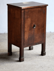 A wooden nightstand with a single cabinet door and a circular knob. It has a flat top and stands on four legs. — 3D model