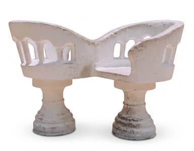 A sculptural white concrete garden bench featuring two distinct seating sections supported by stout pedestal bases. The backrest and armrests form a continuous, curved structure with arch-like cutouts, giving it an architectural and organic appearance. The material shows signs of weathering and age. — 3D model
