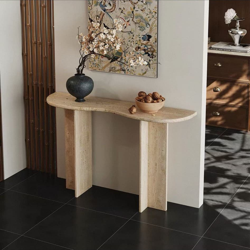 A D-shaped console table crafted entirely from beige travertine, featuring a solid, monolithic construction. — 3D model