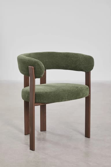 A modern accent chair featuring a curved upholstered backrest and seat in a textured green fabric. The chair has a visible wooden frame with four legs and armrests constructed from dark stained wood. The design is minimalist with clean lines. — 3D model