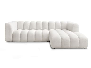 A white, modular sectional sofa with a chaise lounge extension. The sofa features a distinctive channel-tufted design on its seat cushions, backrests, and chaise. The upholstery appears to be a textured boucle fabric. The sofa has a low profile with concealed legs, giving it a contemporary aesthetic. — 3D model