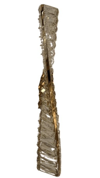A vertical, wall-mounted lighting fixture featuring a polished gold-toned metal frame intricately embellished with numerous clear, faceted crystal elements. The crystals are arranged in a multi-tiered pattern along the central metal structure, designed to refract and reflect light. A rectangular gold-finished mounting plate is visible at the center. — 3D model