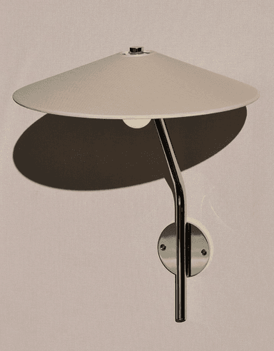 A contemporary wall sconce featuring a wide, conical fabric shade, a curved polished metal arm, and a circular wall-mounted plate, designed for directional or ambient lighting. — 3D model