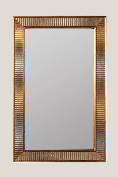 A rectangular wall mirror with a prominent gold-finished frame. The frame features a distinct geometric pattern, characterized by horizontal and vertical grooved lines that create a stepped, Art Deco-inspired design. The gold finish appears somewhat distressed or antiqued, with darker undertones accentuating the grooves. The mirror itself is clear and reflects light without distortion. The overall aesthetic suggests a decorative piece suitable for various interior styles. — 3D model