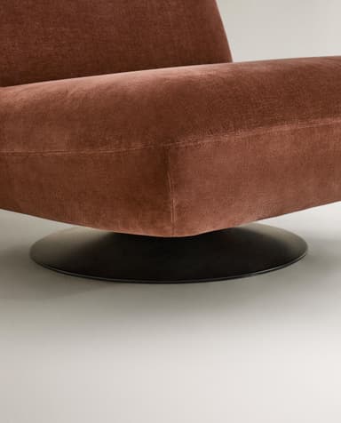 A contemporary armchair with a low profile and plush upholstery. The chair features a rounded silhouette, a supportive backrest, and a deep seat. It is mounted on a circular, black swivel base, allowing for 360-degree rotation. The fabric appears to have a soft, velvety texture. — 3D model