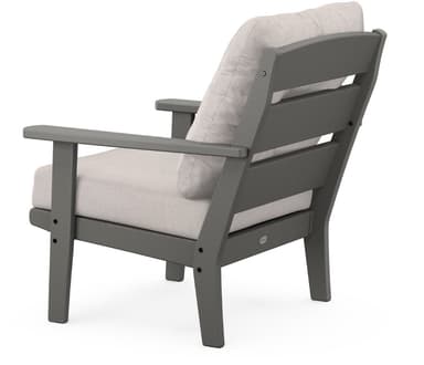 A modern armchair with a sturdy frame and comfortable cushions. The chair features a single-button tufted back cushion and a seat cushion. The armrests are flat and wide. The frame is constructed from what appears to be a durable, weather-resistant material, suitable for outdoor use. The cushions are upholstered in a light-colored, textured fabric. — 3D model