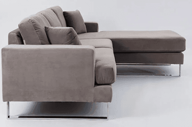 A plush, grey sectional sofa with a chaise lounge extension. The sofa features a modern design with clean lines and supportive back cushions. It is supported by sleek, polished metal legs. — 3D model