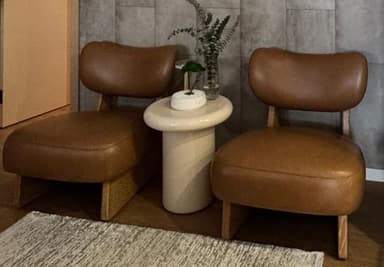 A small, cylindrical stool with a rounded, mushroom-shaped top. The object has a minimalist design and appears to be made of a single material. — 3D model