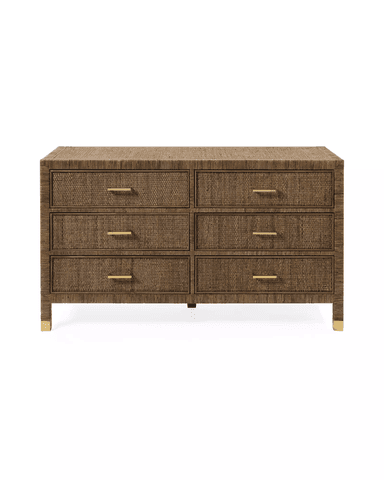 A six-drawer dresser with a woven rattan exterior and brass drawer pulls. The dresser has a rectangular top and rests on four legs, each with a brass-colored cap. — 3D model