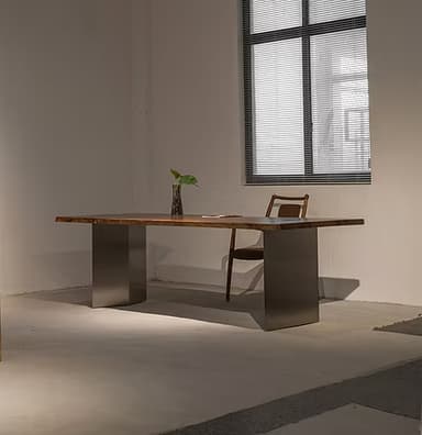 A contemporary dining table featuring a live-edge wooden tabletop and two solid, rectangular metal bases. The tabletop exhibits natural, irregular edges and a prominent wood grain, suggesting a single slab or carefully joined pieces. The bases are dark, matte grey, providing sturdy support and a modern contrast to the organic top. — 3D model