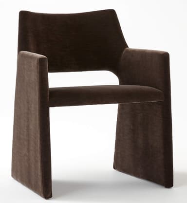 A contemporary dark brown velvet armchair featuring a fully upholstered monolithic design with integrated arms and legs, and a gently curved backrest. — 3D model