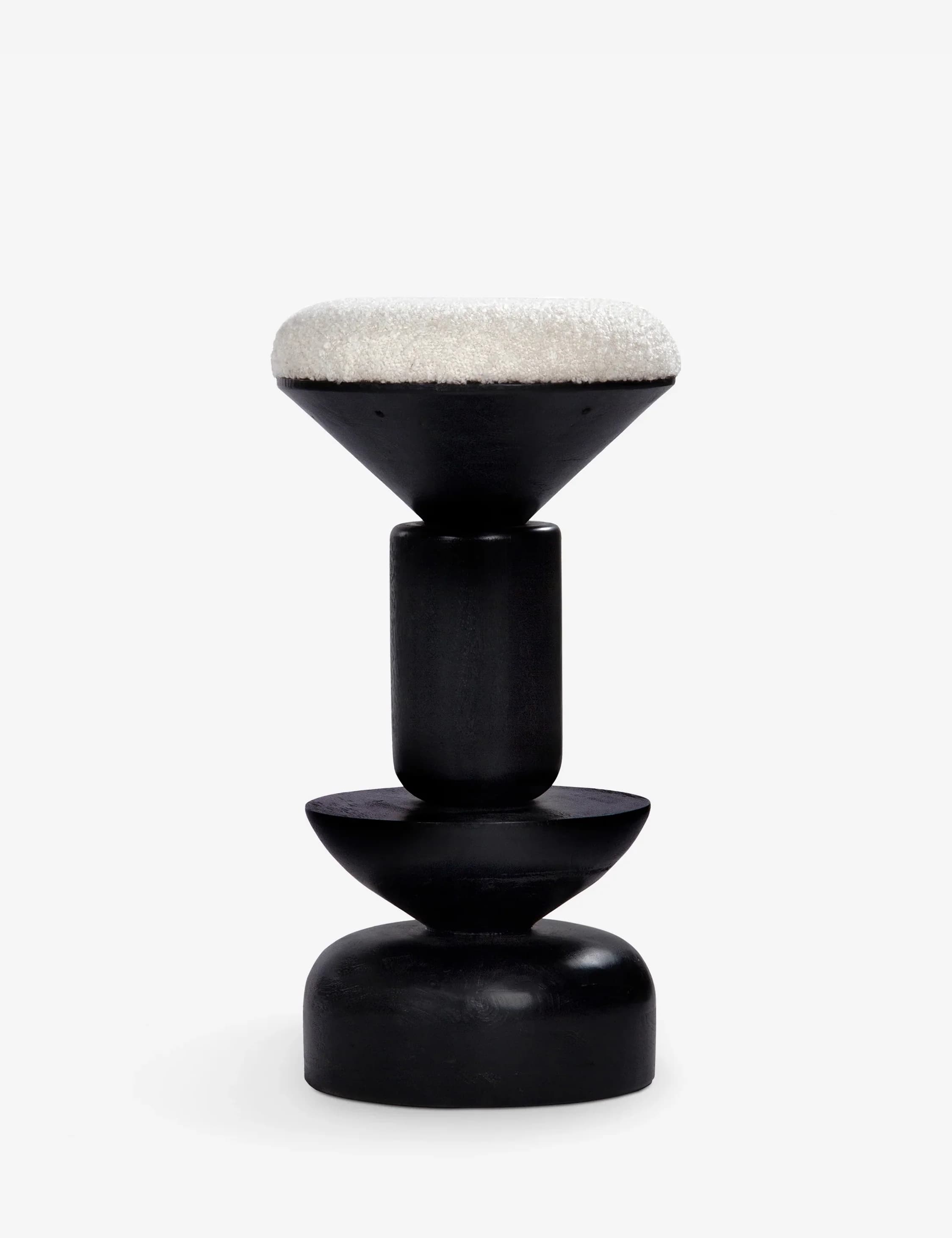 A striking sculptural stool featuring a matte black wooden base composed of stacked geometric shapes and topped with a plush, textured white upholstered seat. The base includes a broad, rounded plinth, an inverted conical section, a cylindrical column, and an upward-flaring conical element that cradles the cushion. The design emphasizes a bold, contrasting aesthetic. — 3D model
