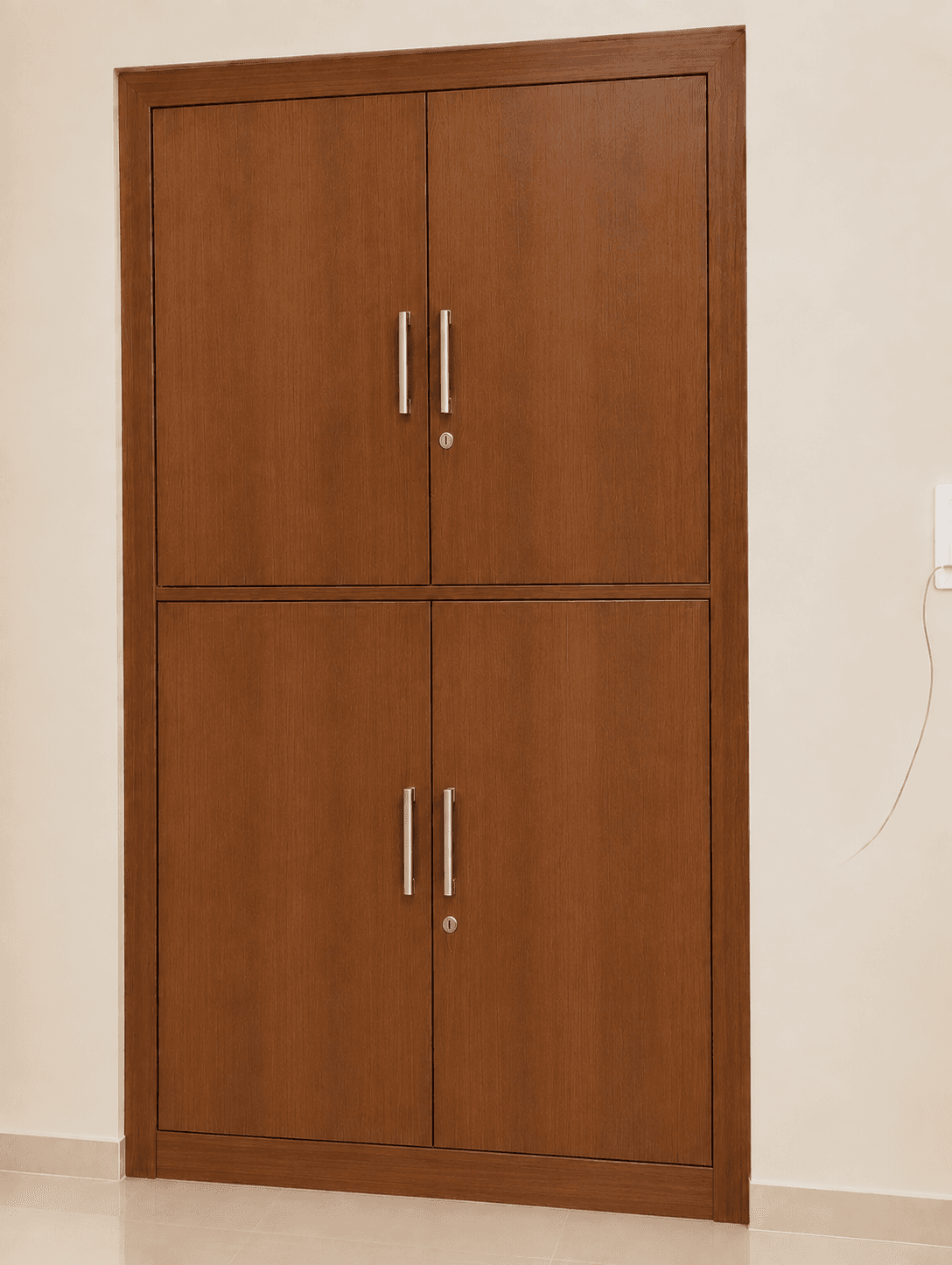 A tall, rectangular wooden storage cabinet finished in a medium brown tone with visible wood grain. The unit features four hinged doors, divided into two distinct upper and lower compartments. Each compartment is secured by two doors, fitted with modern brushed metal bar pull handles and a key lock mechanism. The cabinet stands on a low plinth base. — 3D model