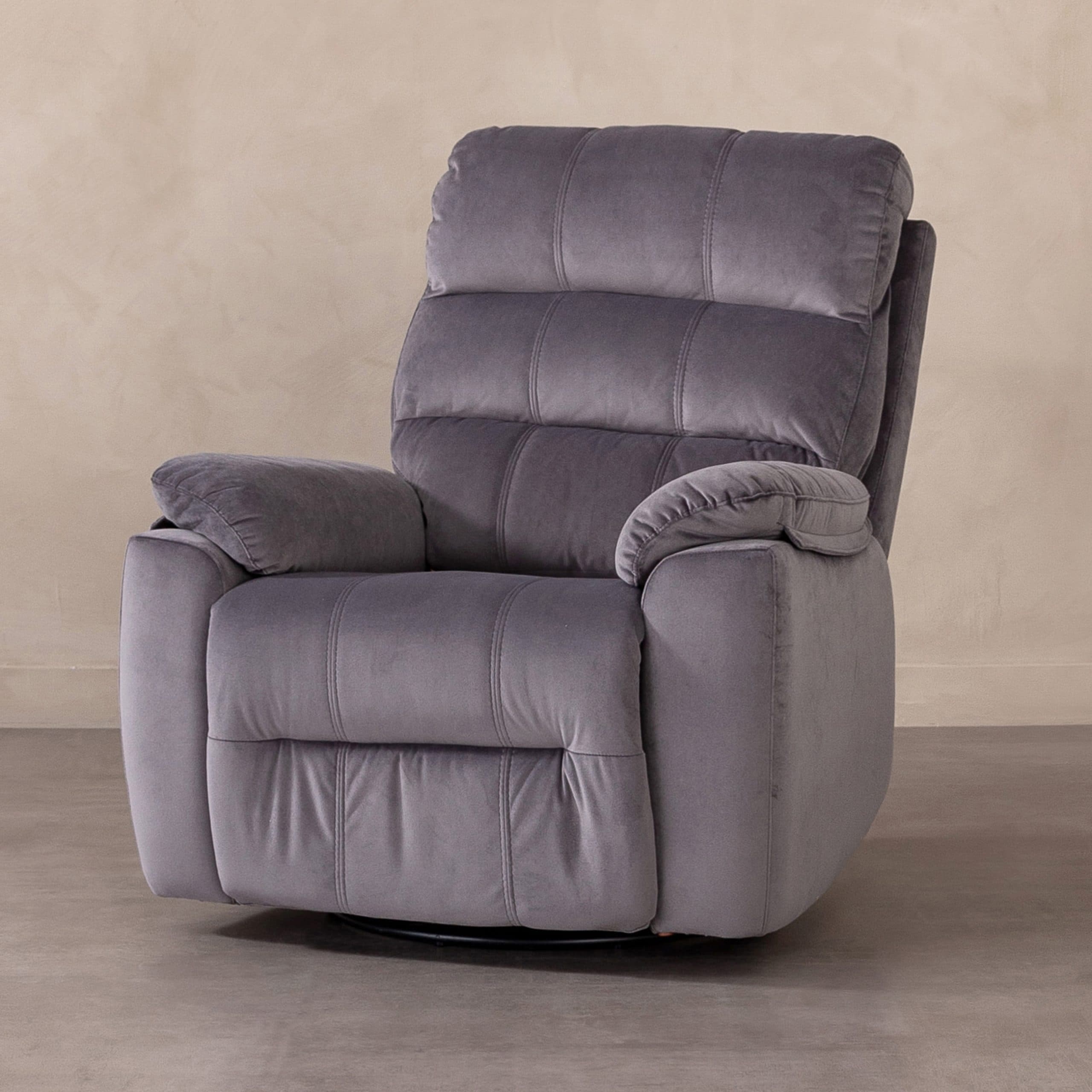 A contemporary grey recliner chair, upholstered in a soft, plush velvet-like fabric. It features heavily padded, segmented cushions on the backrest and seat, and generously padded rolled armrests, all contributing to a comfortable and inviting aesthetic. The chair is designed for relaxation, typically allowing for a reclining backrest and an extending footrest. — 3D model