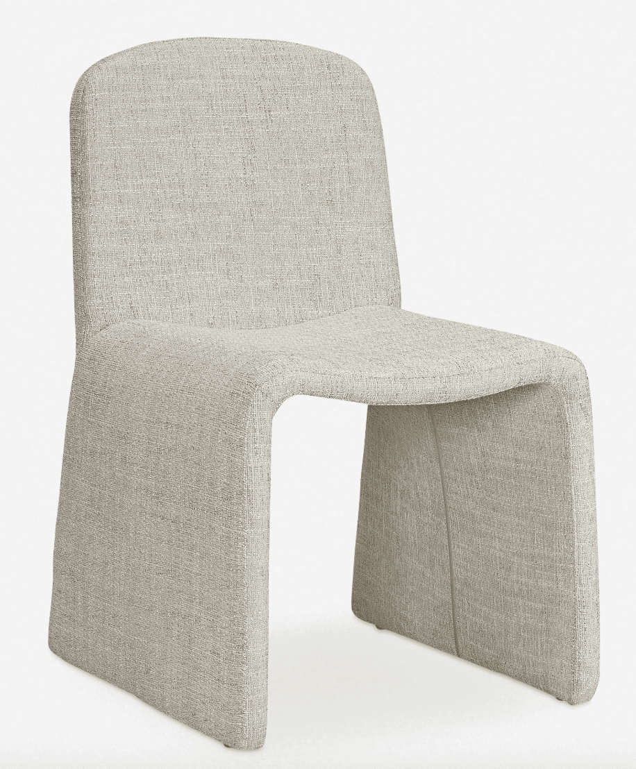 A modern, armless accent chair with a continuous, flowing silhouette. The chair features a rounded backrest that curves down to form the seat and integrated legs. The entire piece is upholstered in a textured, light-colored fabric. — 3D model