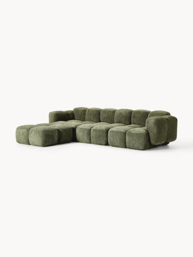 A modular sectional sofa composed of multiple cubic upholstered units. The sofa features a low profile and rounded edges on each module, creating a soft, organic aesthetic. It is upholstered in a textured, boucle-like fabric in a muted green hue. The arrangement suggests a configuration that includes a corner section and extended seating. — 3D model