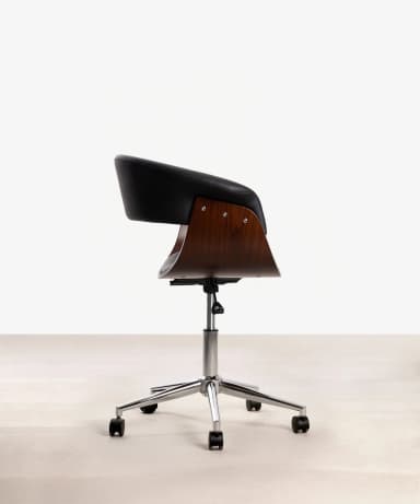 A close-up view of a lounge chair, highlighting its curved bentwood frame in a rich brown finish and contrasting black upholstered seat and backrest. The black upholstery features a subtle pebbled texture and visible stitching, suggesting leather or a high-quality faux leather. The wooden frame exhibits a distinct grain pattern, indicating a molded plywood or bentwood construction that creates a sleek, continuous curve. The design suggests a modern or mid-century aesthetic. — 3D model