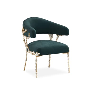 A luxurious barrel-style armchair upholstered in dark teal velvet, featuring an ornate frame with gold-finished metallic sections and sculptural white bone-like embellishments on the arm supports and slender legs. — 3D model