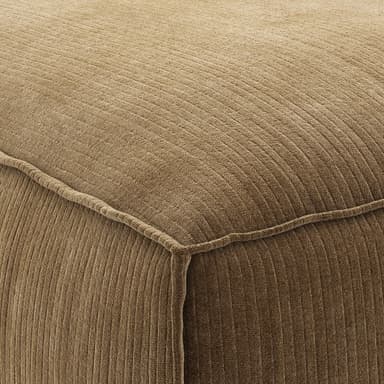 A low-profile, upholstered corner armchair with a modular design. It features a deep seat cushion and a wrap-around backrest forming a corner configuration. The upholstery has a distinct corduroy texture. — 3D model
