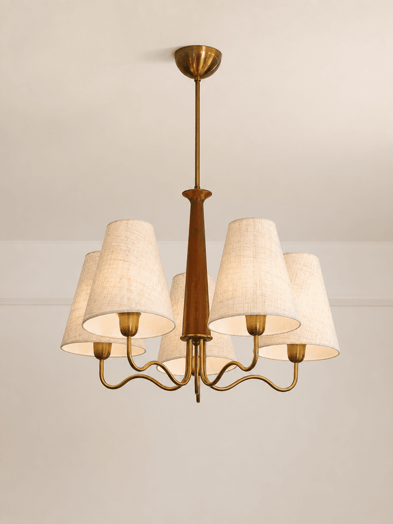 A multi-arm chandelier featuring a brass frame, a central wooden column, and five tapered fabric shades. The fixture is suspended by a brass rod and canopy. — 3D model