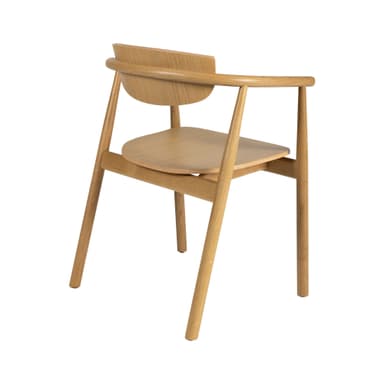 A light-colored wooden armchair with a curved backrest and armrests. The seat is a circular wooden panel. The legs are cylindrical and taper slightly towards the floor. The construction appears to be solid wood with visible grain patterns. The overall design is minimalist and contemporary. — 3D model