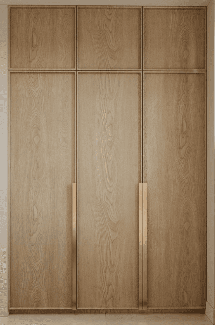 A tall, freestanding wardrobe with three doors. The doors feature a wood grain pattern and are divided horizontally into two sections. Each door has a long, minimalist brass-colored handle. — 3D model