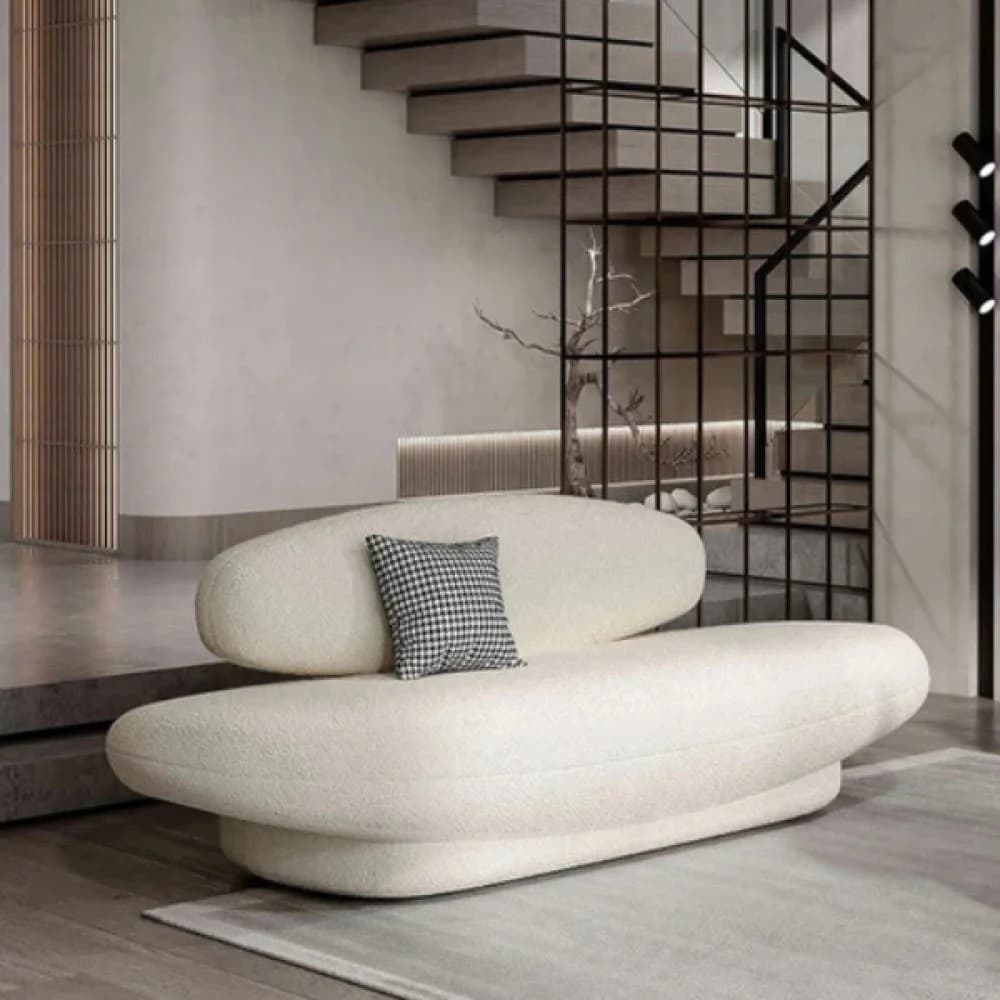 A contemporary, organic-shaped sofa upholstered in a cream bouclé fabric, featuring a long, low base and a separate, elevated backrest, designed for comfortable lounging. — 3D model