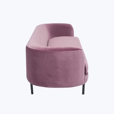 A pink velvet sofa with a curved back and arms, featuring a single seat cushion and a slender black base with four legs. — 3D model
