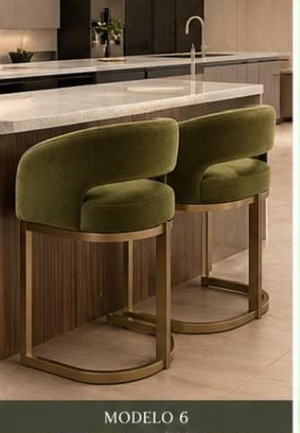 A contemporary bar stool featuring an upholstered barrel-shaped seat with an open cut-out back, supported by a gold-tone metal frame with a sled base and integrated footrest. The upholstery is a textured olive green fabric. — 3D model