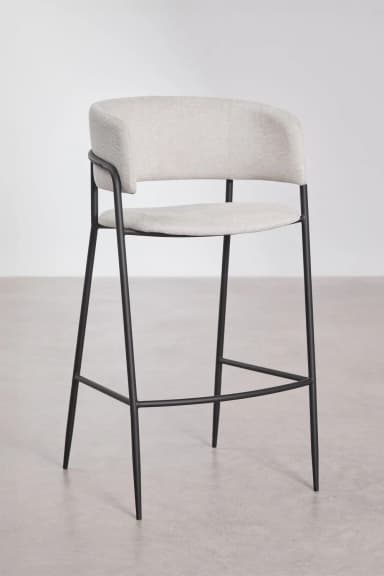 A modern bar stool featuring a light gray upholstered seat and a wraparound backrest that seamlessly integrates armrests. The seat and back are cushioned, providing comfort. The entire upholstered section is supported by a slender black metal frame which forms the four legs, reinforced by a circular footrest at the bottom. The design is minimalist and contemporary. — 3D model