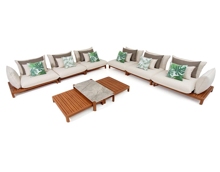 An outdoor modular sectional lounge set, comprising several individual seating units with light-toned wooden frames, off-white cushions, and decorative throw pillows, arranged in a U-shape around a central two-tiered coffee table with slatted wood and a stone-like top. — 3D model