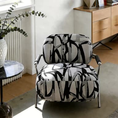 A modern armchair featuring a barrel-style upholstered seat and back, supported by an exposed tubular metal frame that also forms the armrests. The upholstery has a distinctive abstract black, grey, and white pattern. Dimensions are indicated as 71cm (height), 84cm (width), and 81cm (depth). — 3D model