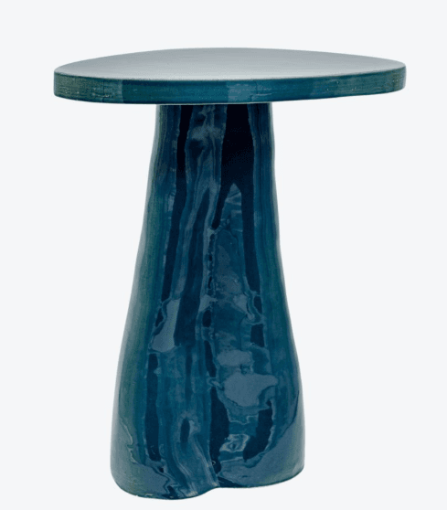 A ceramic side table with an organic, mushroom-like form. It features a flat, slightly oval tabletop and a substantial, tapering pedestal base. The glaze exhibits a marbled effect with varying shades of blue and green, creating a fluid, dynamic appearance. — 3D model