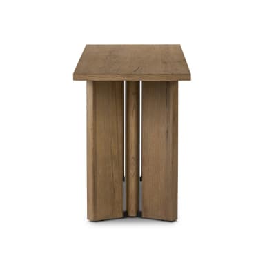A minimalist side table constructed from solid wood, featuring a rectangular top and a base composed of thick vertical planks. The wood displays a natural grain and a medium brown finish, suggesting a rustic yet contemporary aesthetic. The base has a split, slatted design, offering a unique architectural element. — 3D model