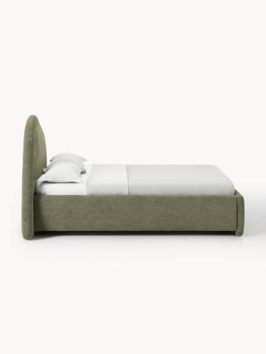 This is an image of a modern upholstered platform bed featuring a distinctive, large, and sculptural curved headboard. The bed frame and headboard are entirely covered in a textured, muted green/khaki fabric. The headboard curves upwards and then gently back, creating a visually interesting silhouette. The rear of the headboard appears to be finished in a darker, contrasting fabric or material. A white mattress and simple white bedding are visible on the bed frame. — 3D model