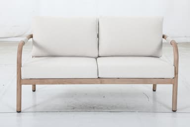 A two-seater sofa with a light-colored wooden frame and light-colored fabric upholstery. The frame features curved armrests and a simple rectangular base. The seat and back cushions are separate and appear to be filled with a soft material. — 3D model