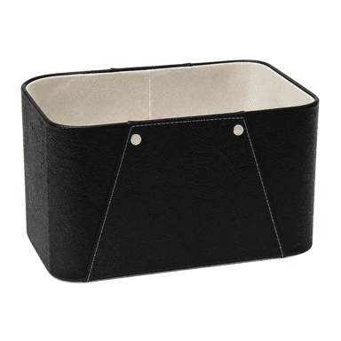 A rectangular storage basket featuring a textured black faux leather exterior and a contrasting light-colored fabric interior lining. The basket is detailed with light-colored saddle stitching along its edges and seams, and accented with four brass-toned studs, two on each wider side. Its structure is rigid, suggesting a reinforced frame underneath the covering materials. The top edge is neatly finished with a rounded trim. — 3D model