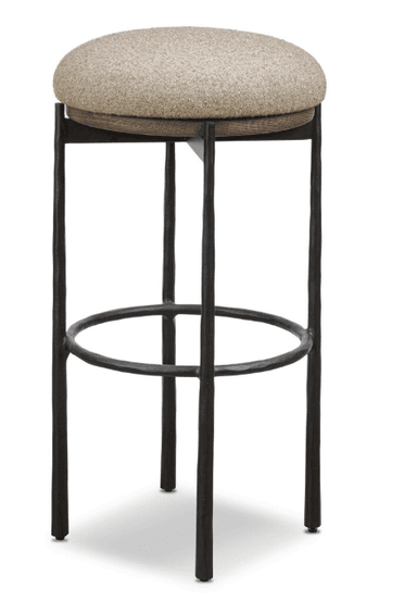 A bar stool featuring a round, upholstered seat made from a light beige, textured fabric, supported by a dark-stained wooden rim. The base consists of four dark, possibly forged or cast metal legs with an uneven, textured surface, connected by a circular metal footrest for stability and comfort. The overall aesthetic combines rustic and industrial elements. — 3D model